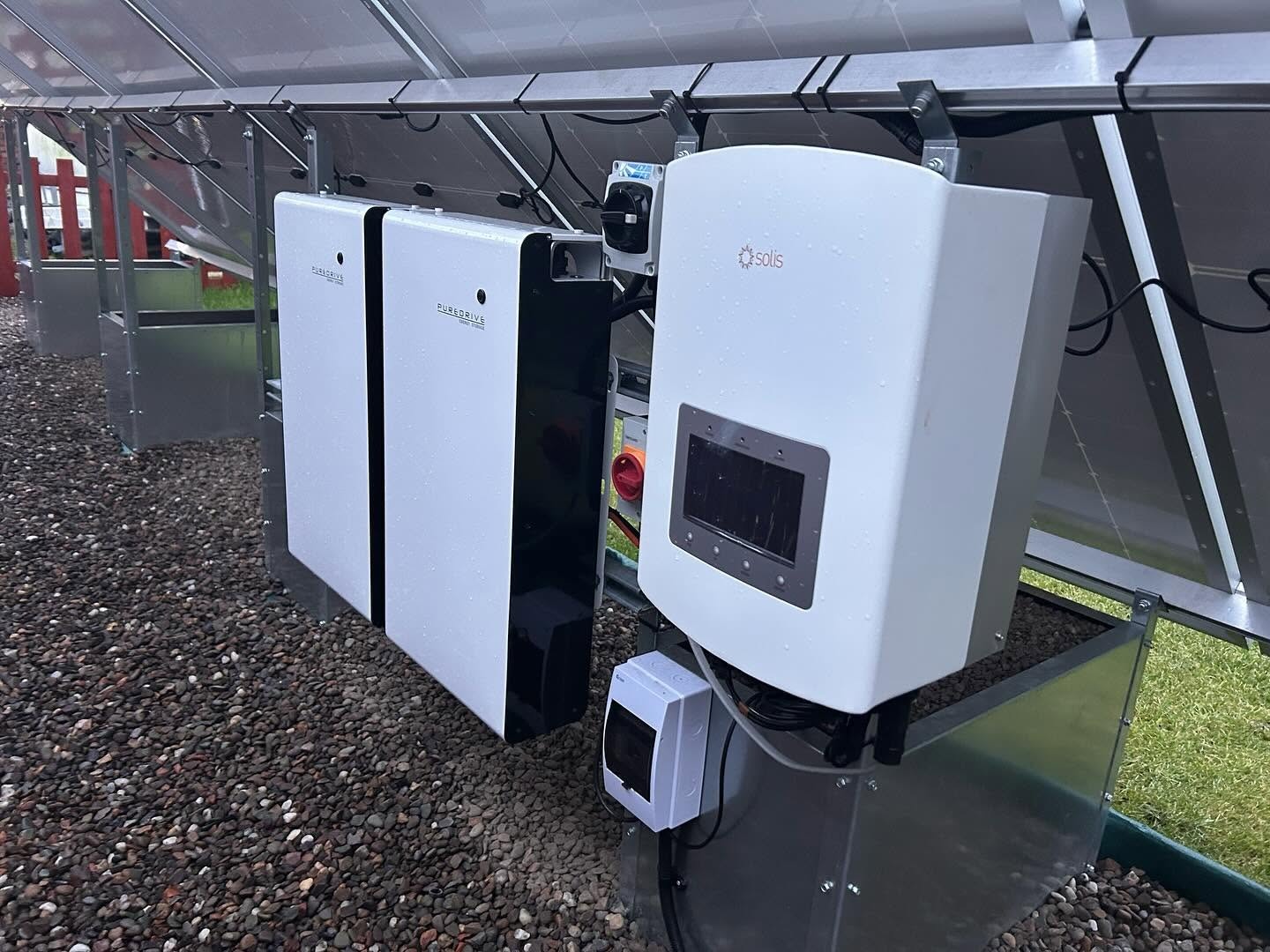 Battery and inverter installation beneath a solar structure
