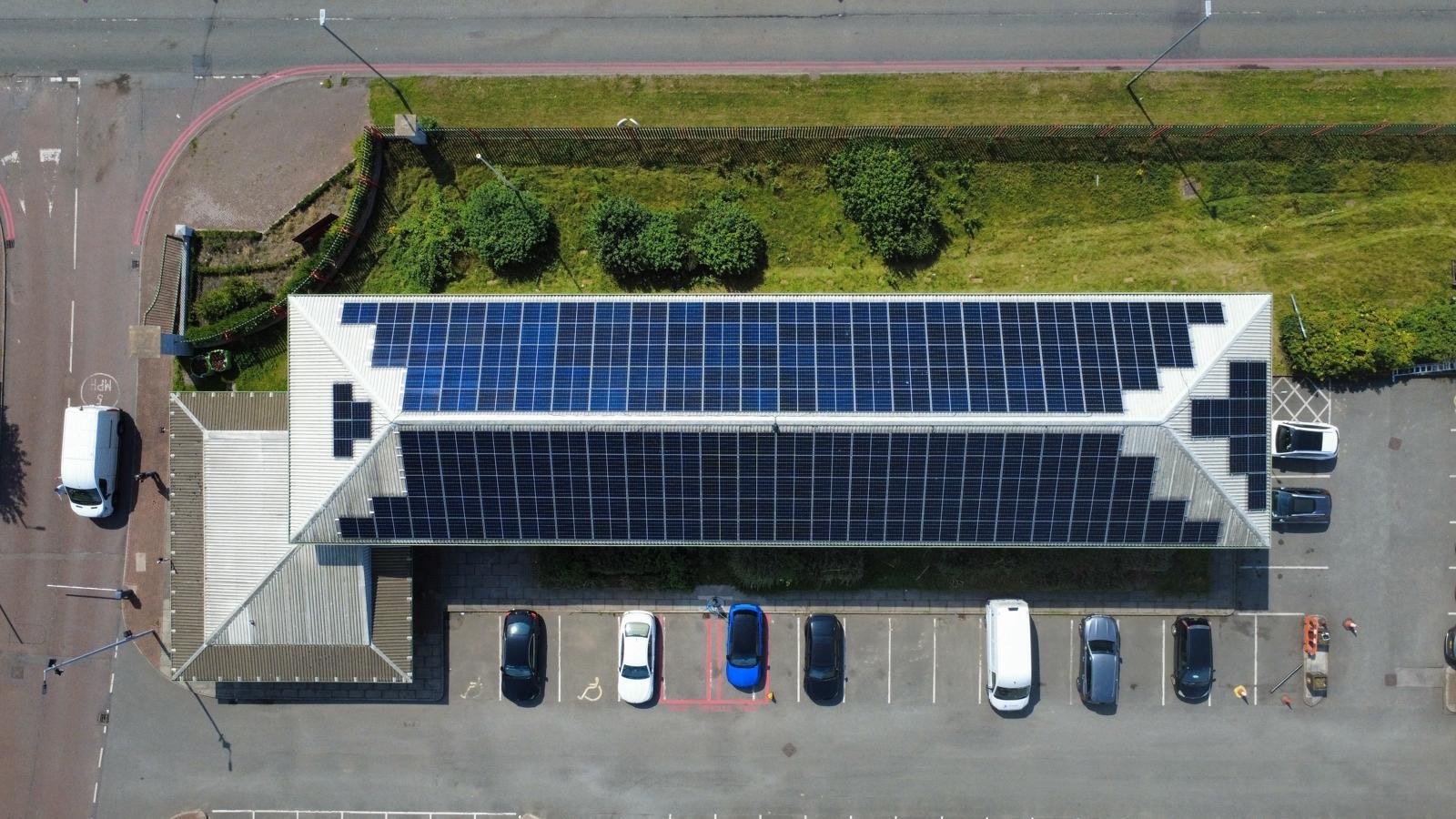 Aerial view of a commercial rooftop solar installation